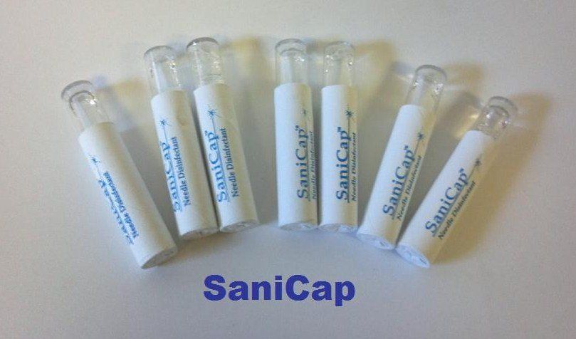 A bunch of white tubes with the word sanicap on them