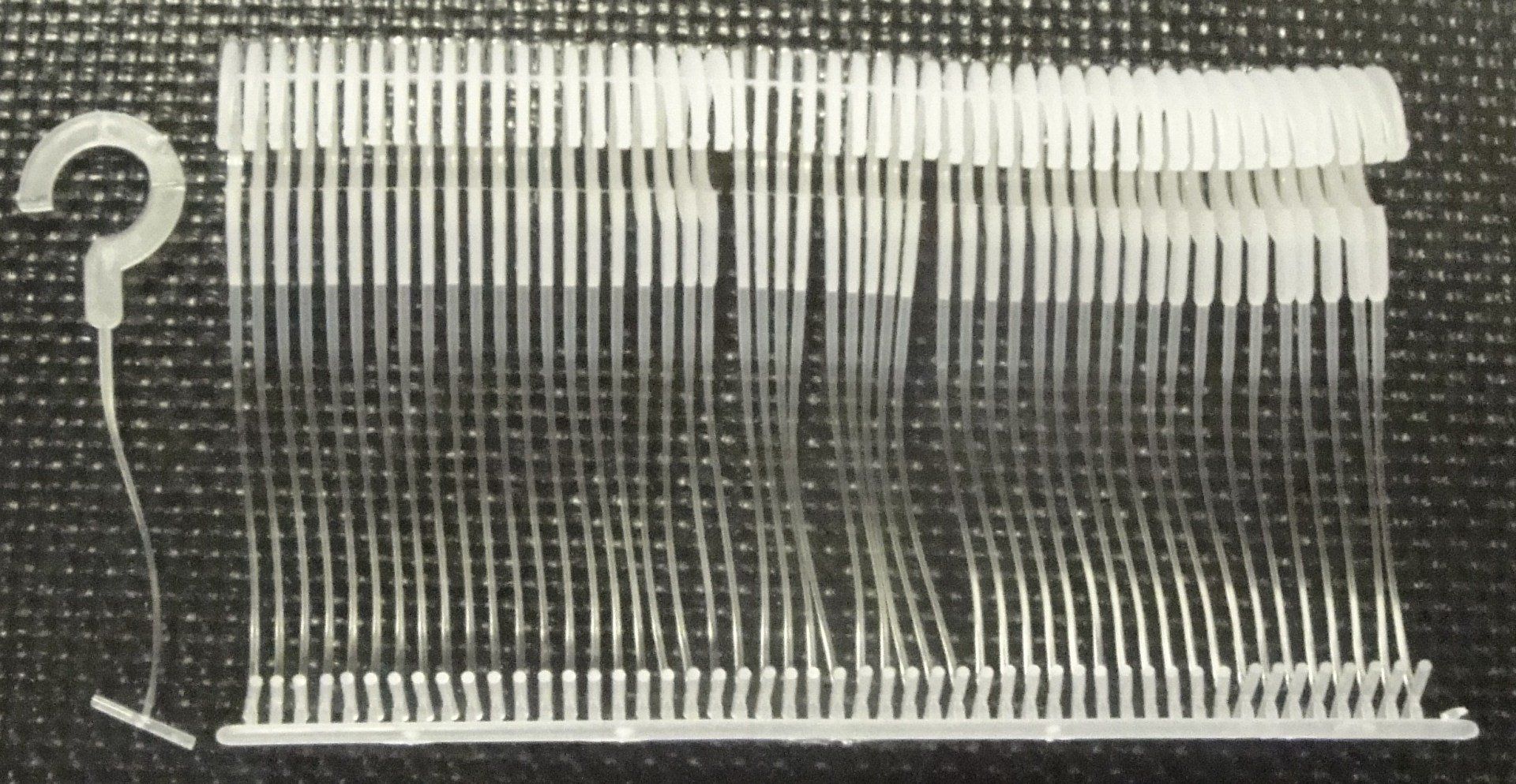 A bunch of white pins with a hook attached to them