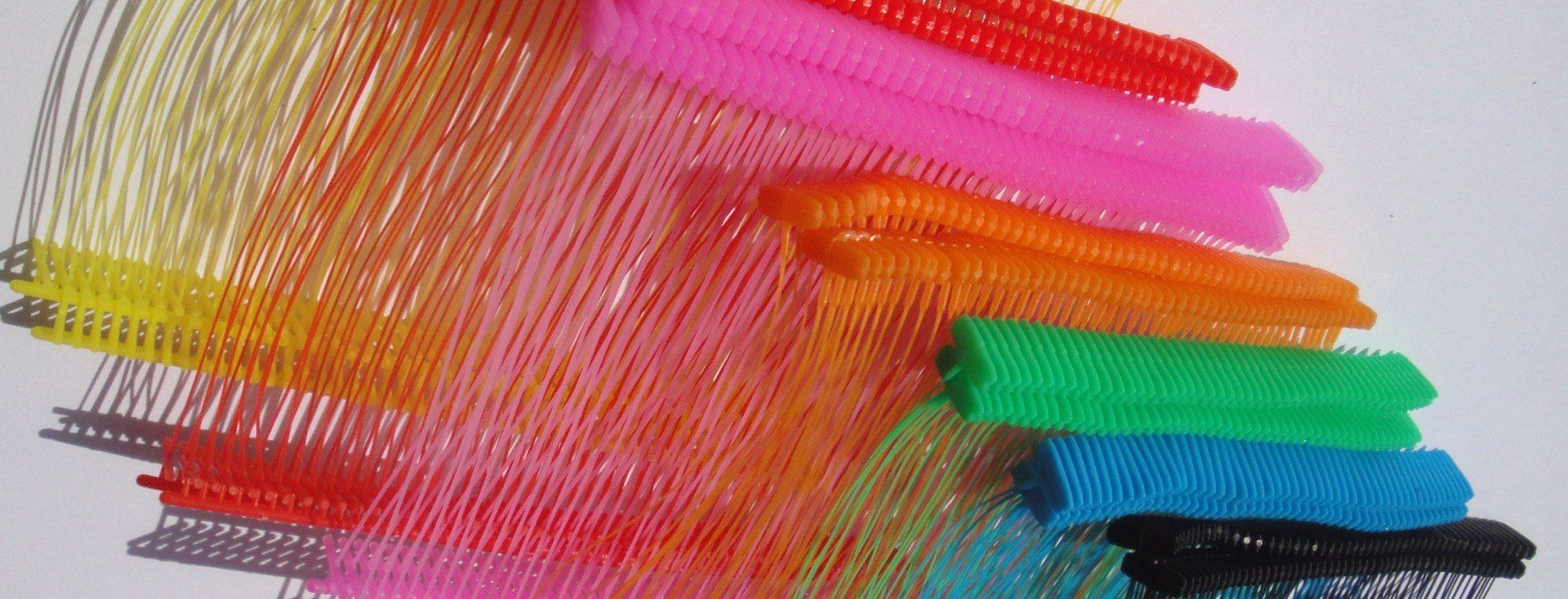 A bunch of colorful pens are sitting on a table.
