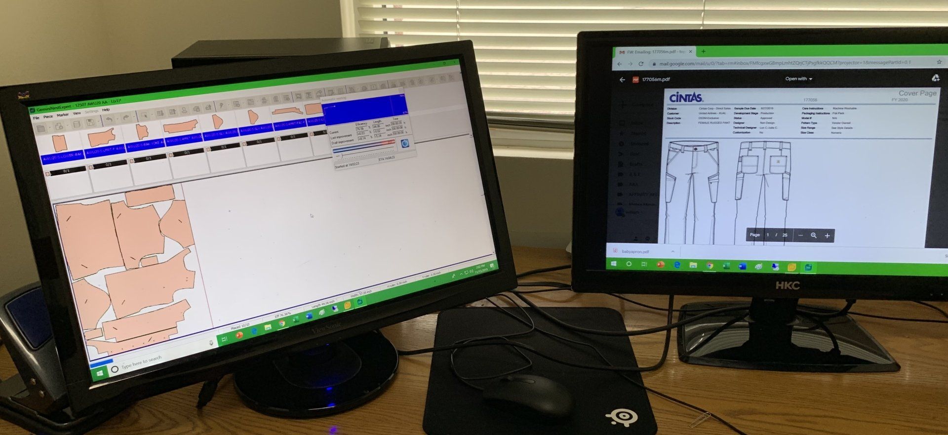 Two computer monitors are sitting next to each other on a desk.