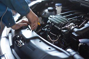 Car Repair — Man Checking the Engine in Lansing, IL Car Repair — Man Checking the Engine in Lansing, IL
