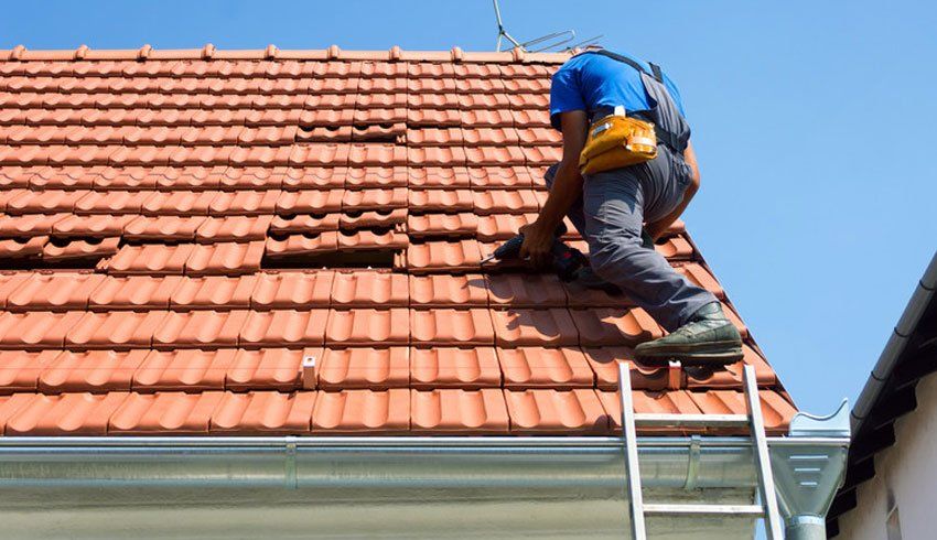 Man fitting tiled roof