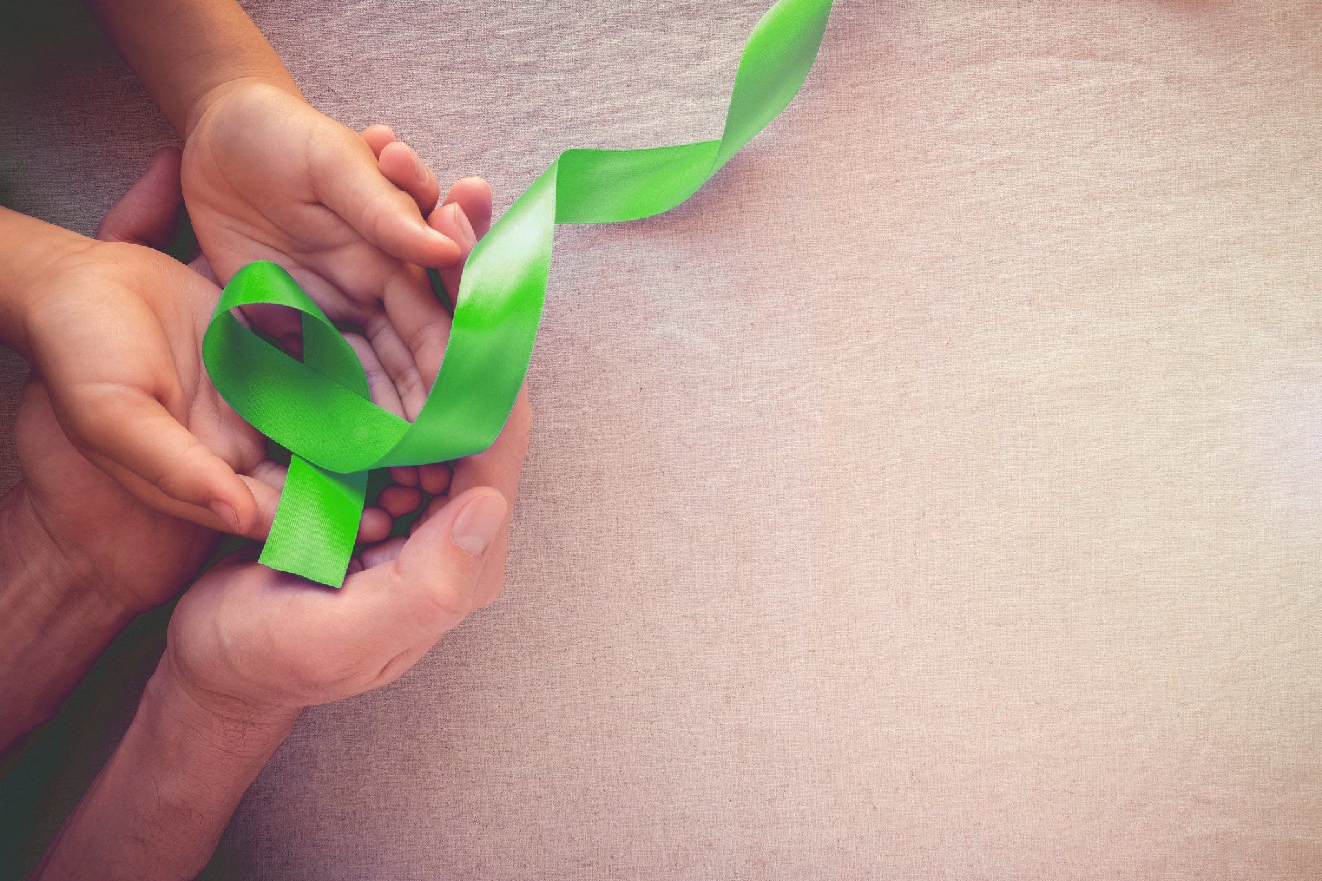 Assessments — Adult and Child holding Green Ribbon in North Hudson, WI