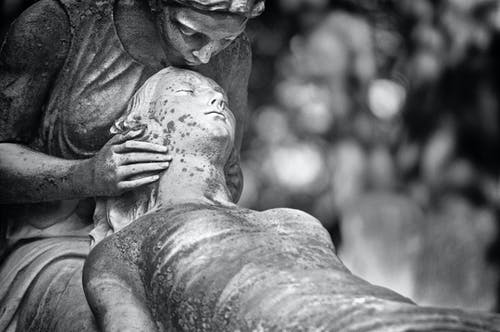 Sitting statue holding dead statue reminds us about life