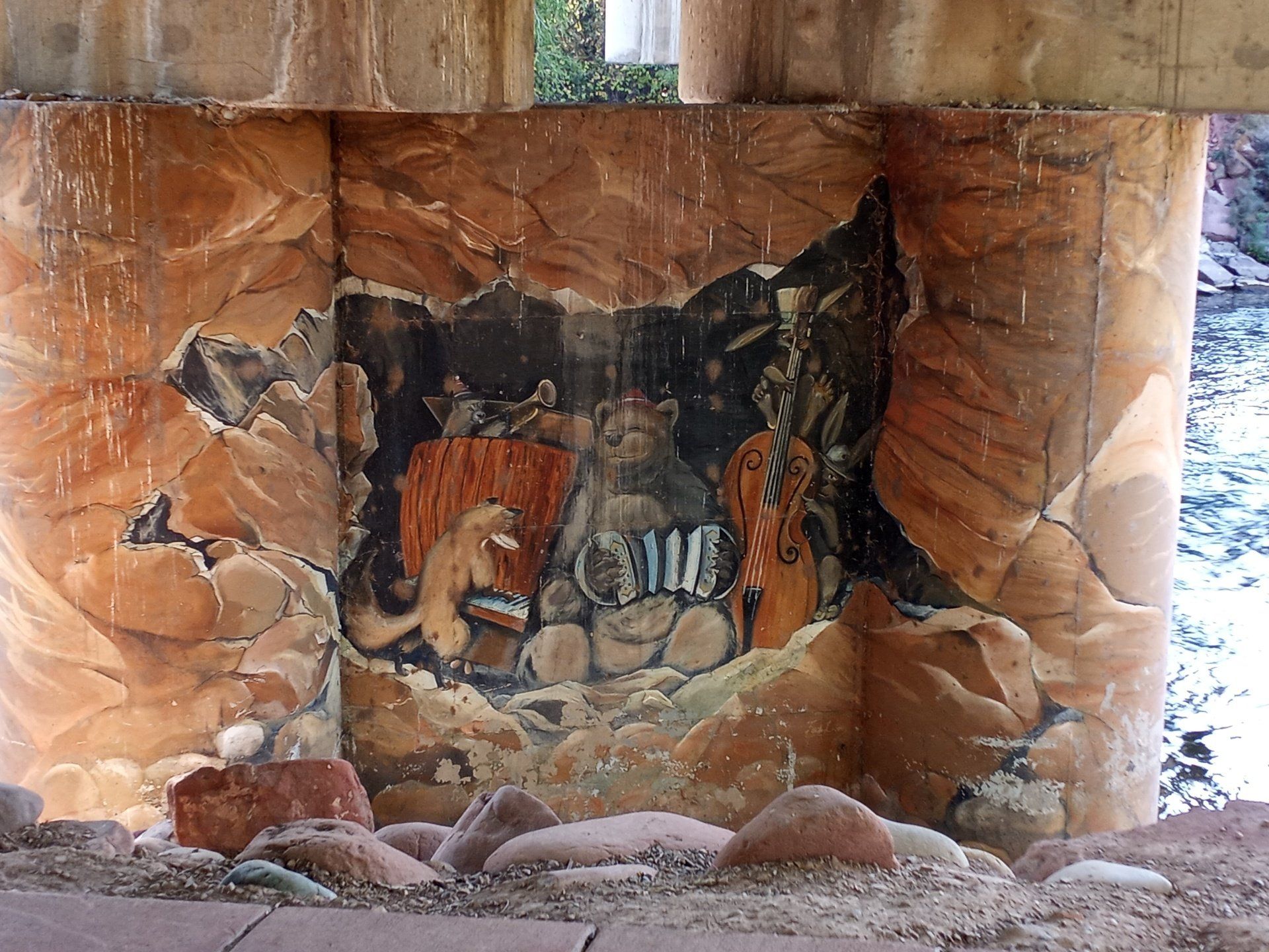 graffiti art under bridge of animals in a band