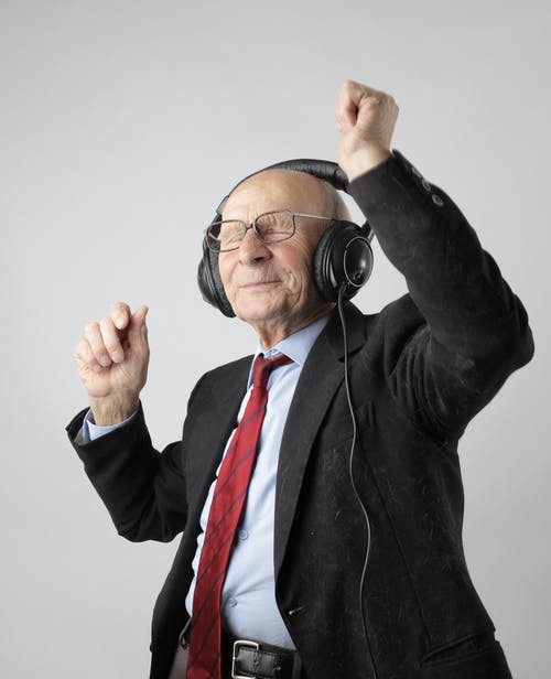 old man eyes closed headset happy