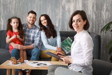 Female psychologist working with family in office