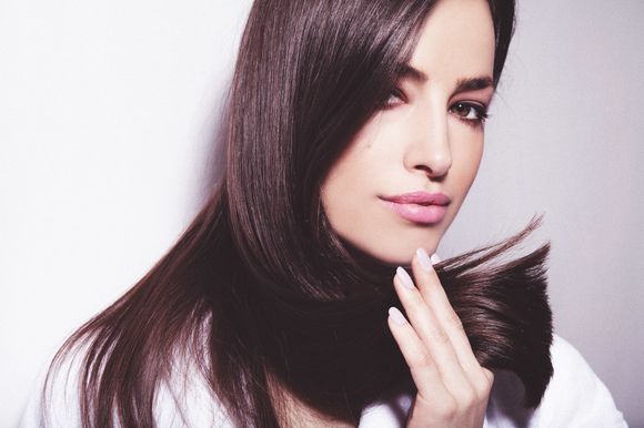 woman holding her hairs after haircut