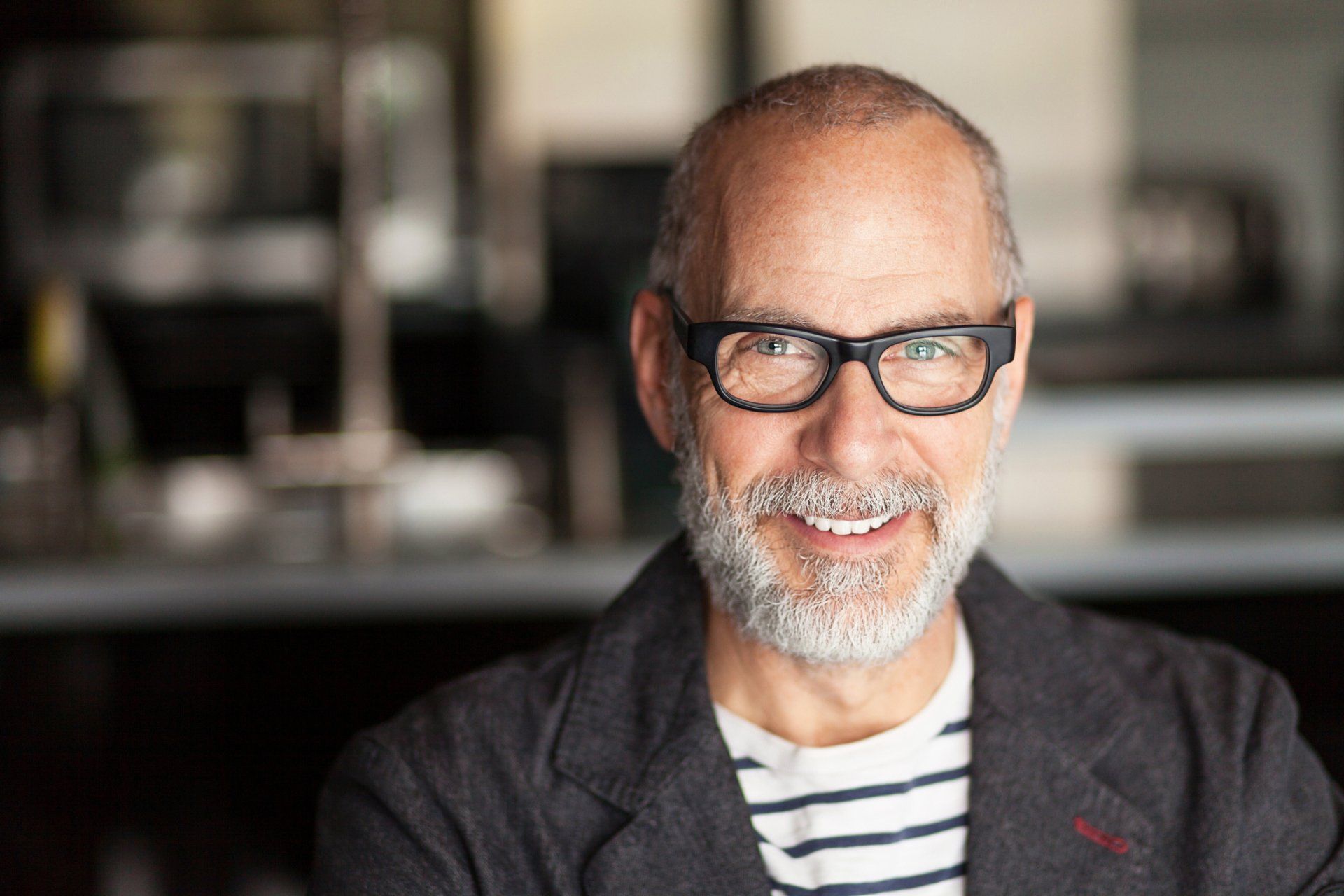 older man in glasses smiling