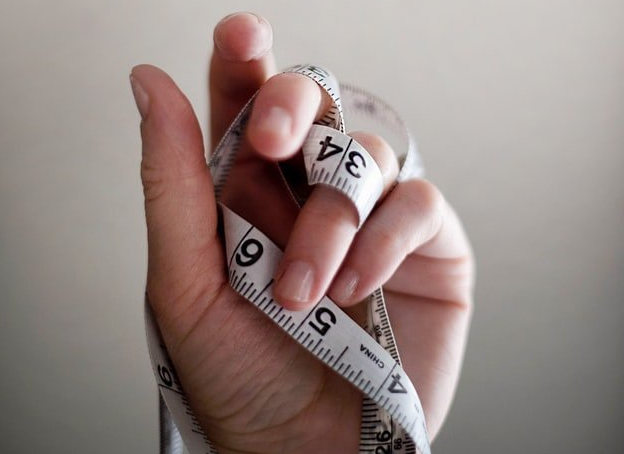 A person is holding a measuring tape