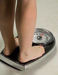 A person is standing on a scale with their feet on it.