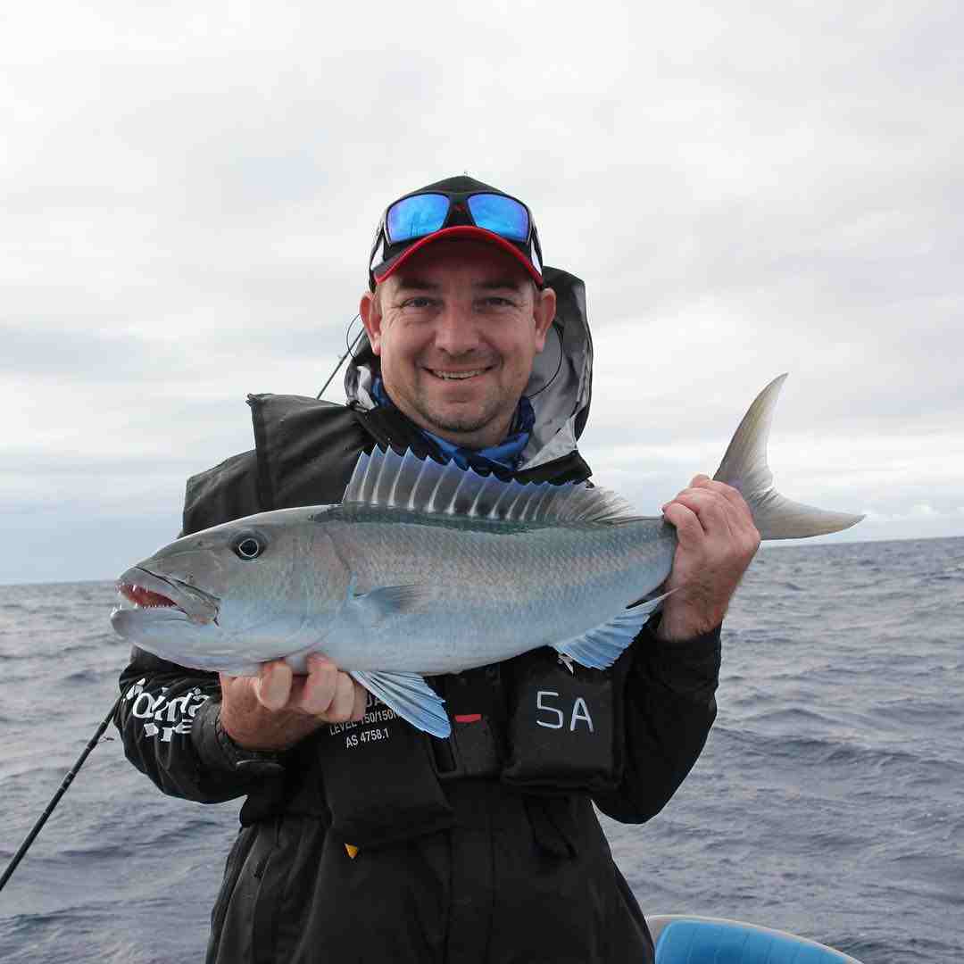 man holding a fish — Fishing apparel Yeppoon in Yeppoon, QLD