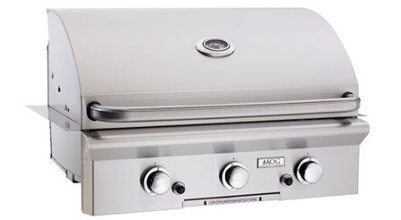 A stainless steel grill with three knobs on a white background.