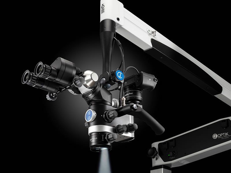 A close up of a dental microscope with a light coming out of it.