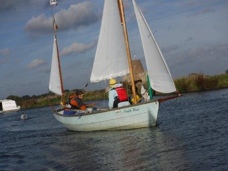 A small sailboat is floating on top of a body of water.
