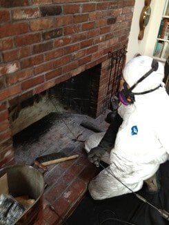 Employee Cleaning Fireplace - Chimney Cleaning Services in Norwood, MA Employee Cleaning Fireplace - Chimney Cleaning Services in Norwood, MA