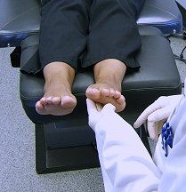 Foot Injury — Doctor Checking the Foot of Woman Patient in Reno, NV Foot Injury — Doctor Checking the Foot of Woman Patient in Reno, NV