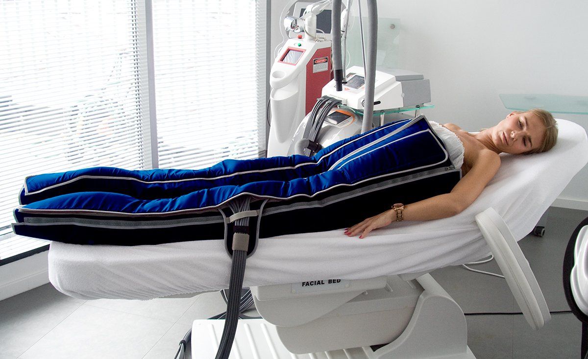 Lying Woman Undergoes Advanced Compression Therapy — Solon, OH — Core Elite Wellness Fit Cryo LLC