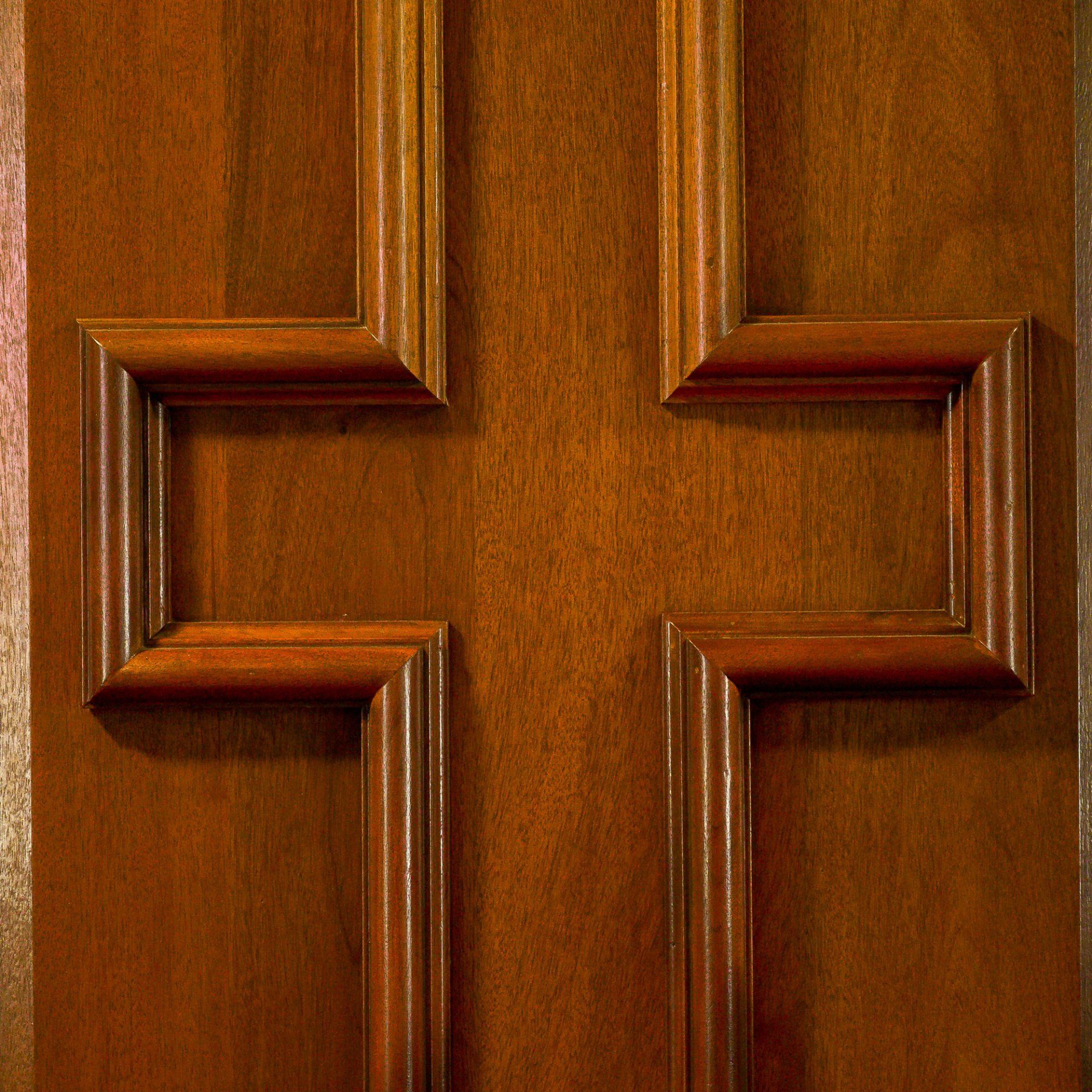 a wooden door with a cross on it