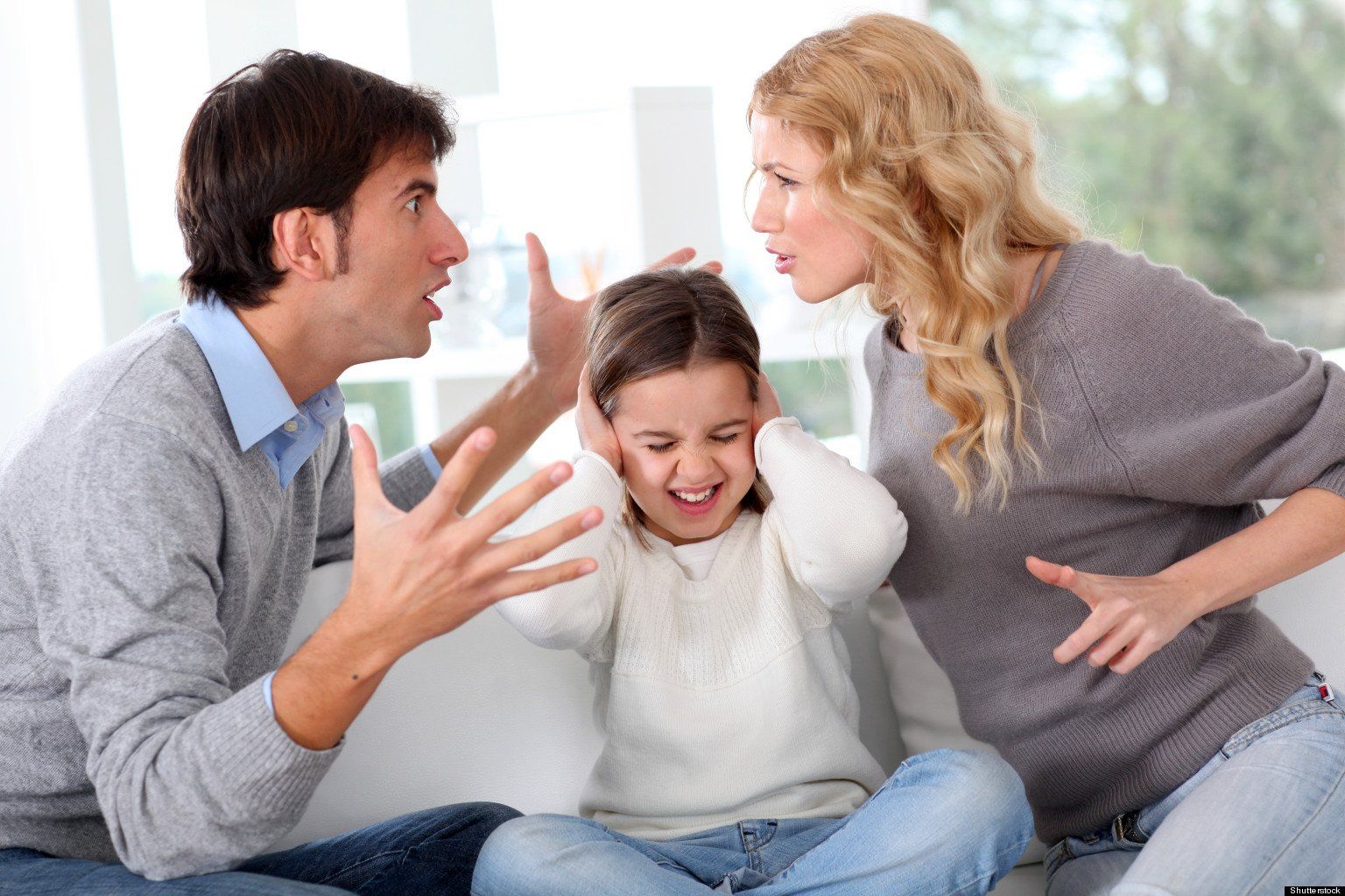 Upset child with screaming parents