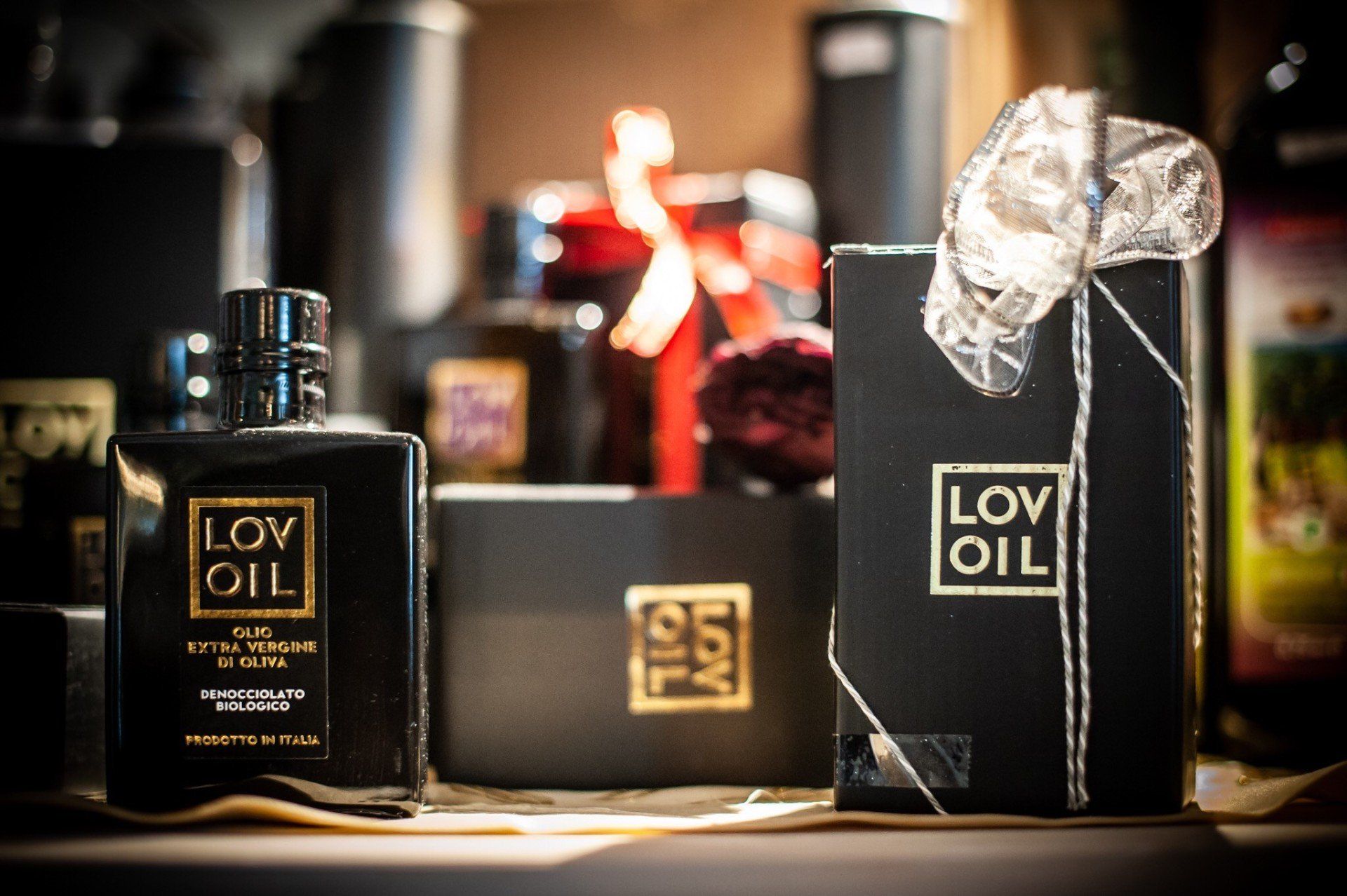 Una bottiglia di profumo Lov Oil è appoggiata su un tavolo accanto a una scatola.