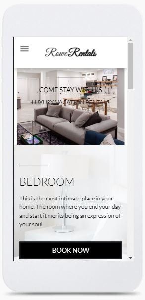 A white cell phone with a picture of a bedroom on the screen.