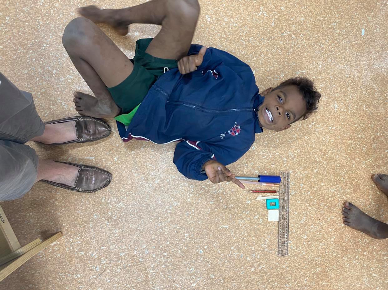 JPP Mulan student next to ruler measuring items