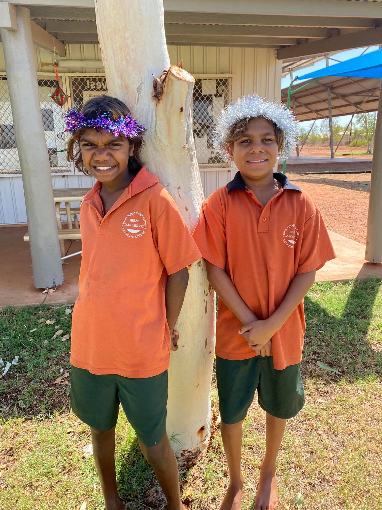 Students standing next to tree