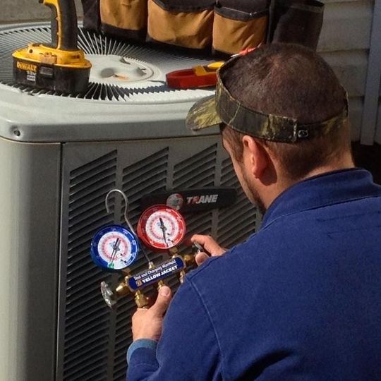 Air Conditioning Repair - Man Repairing a HVAC in Spartanburg, SC Air Conditioning Repair - Man Repairing a HVAC in Spartanburg, SC