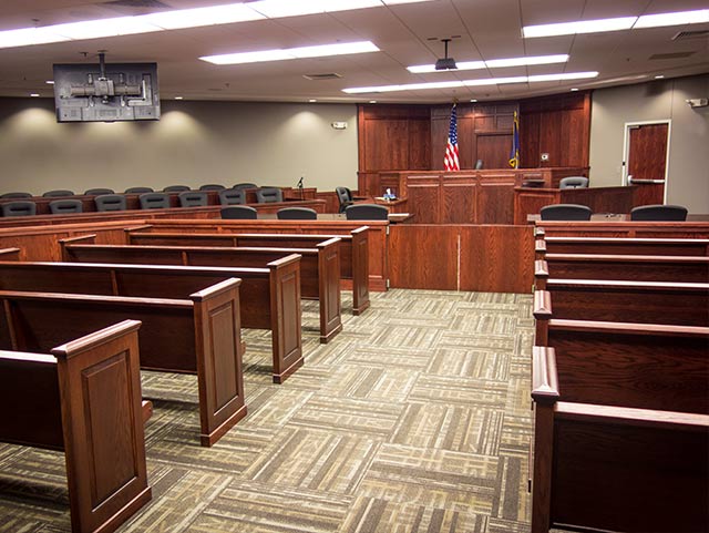 A row of wooden benches in a courtroom