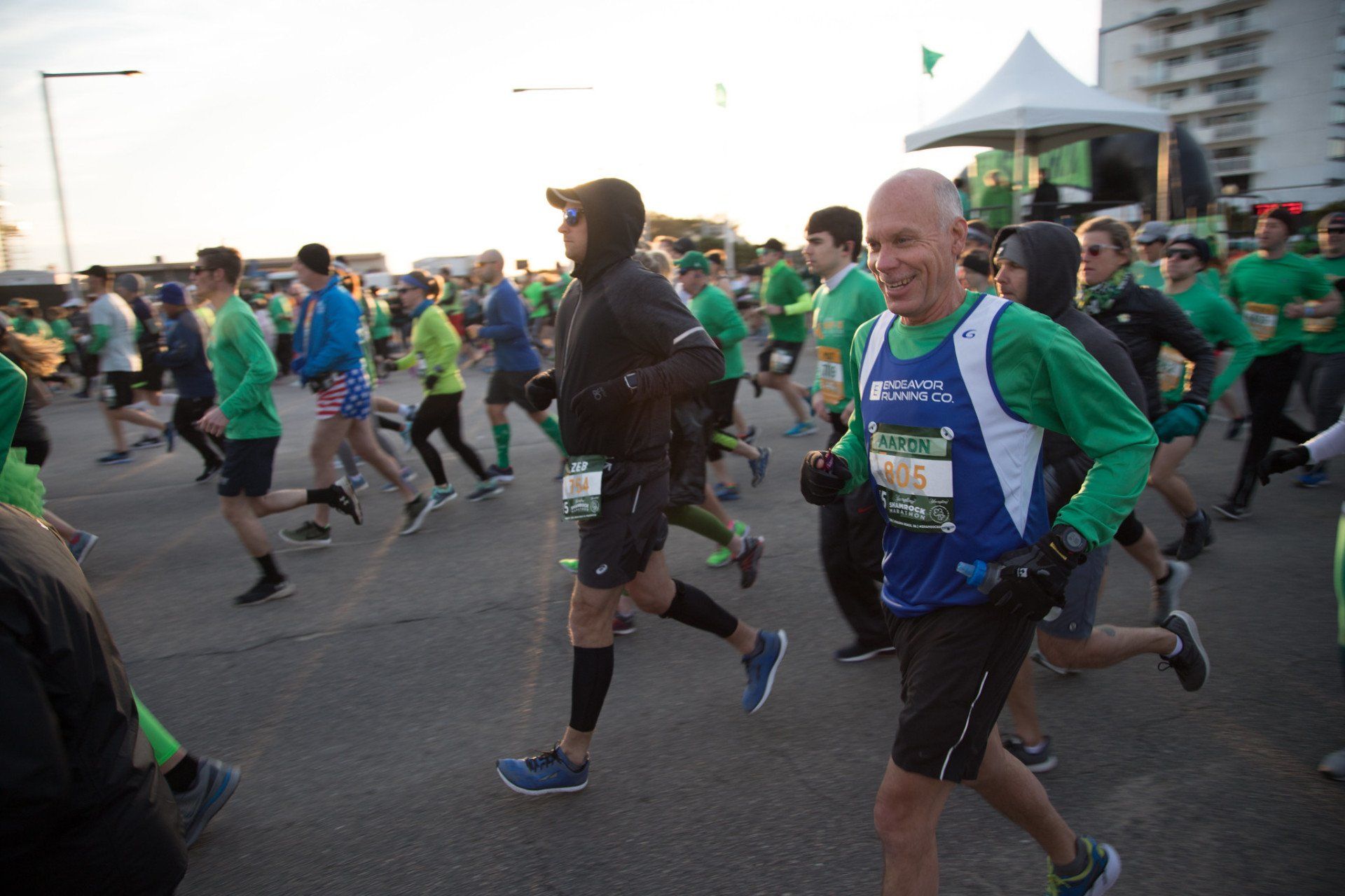 A group of people are running a marathon on a street.
