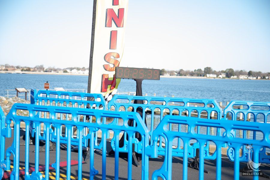A blue fence with a sign in the background that says finish