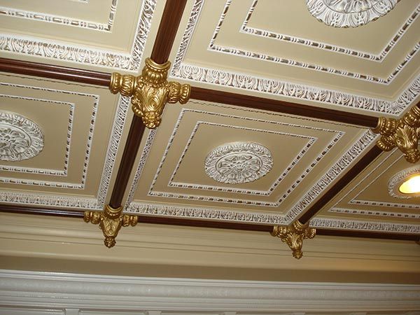 Ornate coffered ceiling with gold and brown accents.