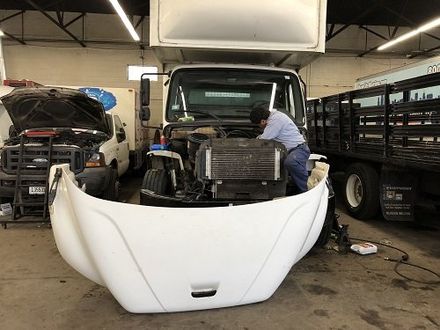 Mechanic under car changing oil — Auto Repair in Chicago, IL Mechanic under car changing oil — Auto Repair in Chicago, IL