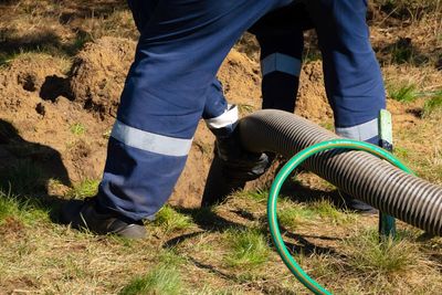 Worker Cleaning Septic Tank — Atlanta, GA — Akins Plumbing Worker Cleaning Septic Tank — Atlanta, GA — Akins Plumbing