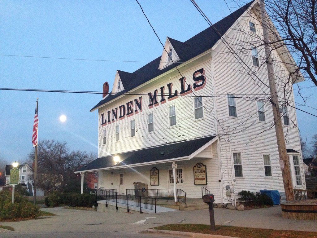 A large white building with linden mills written on it