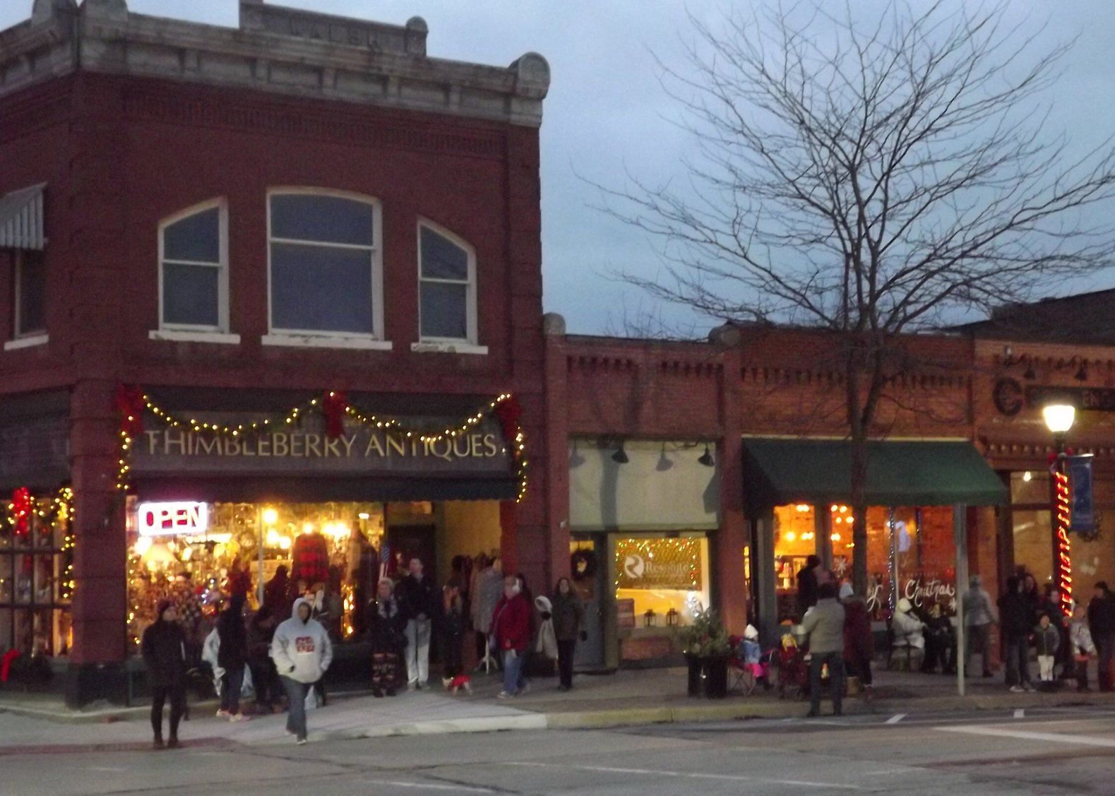 A store front with a sign that says open on it