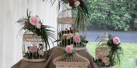 White cages featuring floral designs