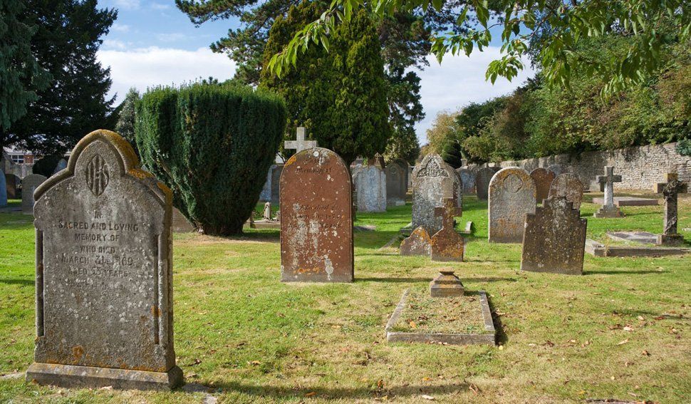 A graveyard with old, lichen-covered graves