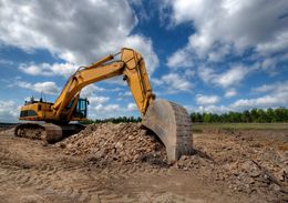 a yellow excavator digging