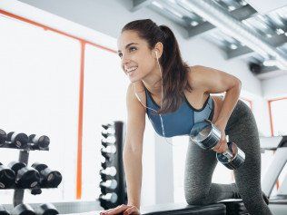 Woman doing exercises with dumbbell