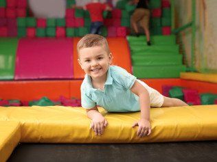 A child smiling while looking at the camera