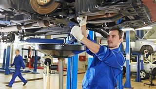 Auto mechanic at car suspension repair work - auto repair shop in san bernardino, CA