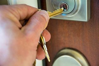 Lock Out Services — Man's Hand Unlocking the Door in Encinitas, CA Lock Out Services — Man's Hand Unlocking the Door in Encinitas, CA