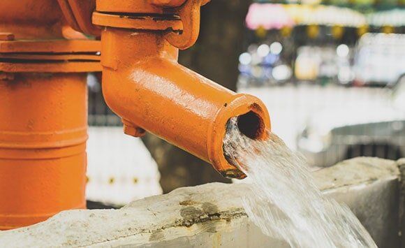 Orange water pump — Well drilling services in Newville, PA Orange water pump — Well drilling services in Newville, PA