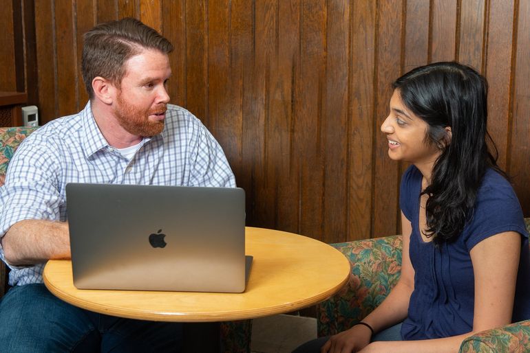 A picture of Grayson Stalvey, a Financial Coach in Cincinnati, Ohio, reviewing debt elimination with a client.