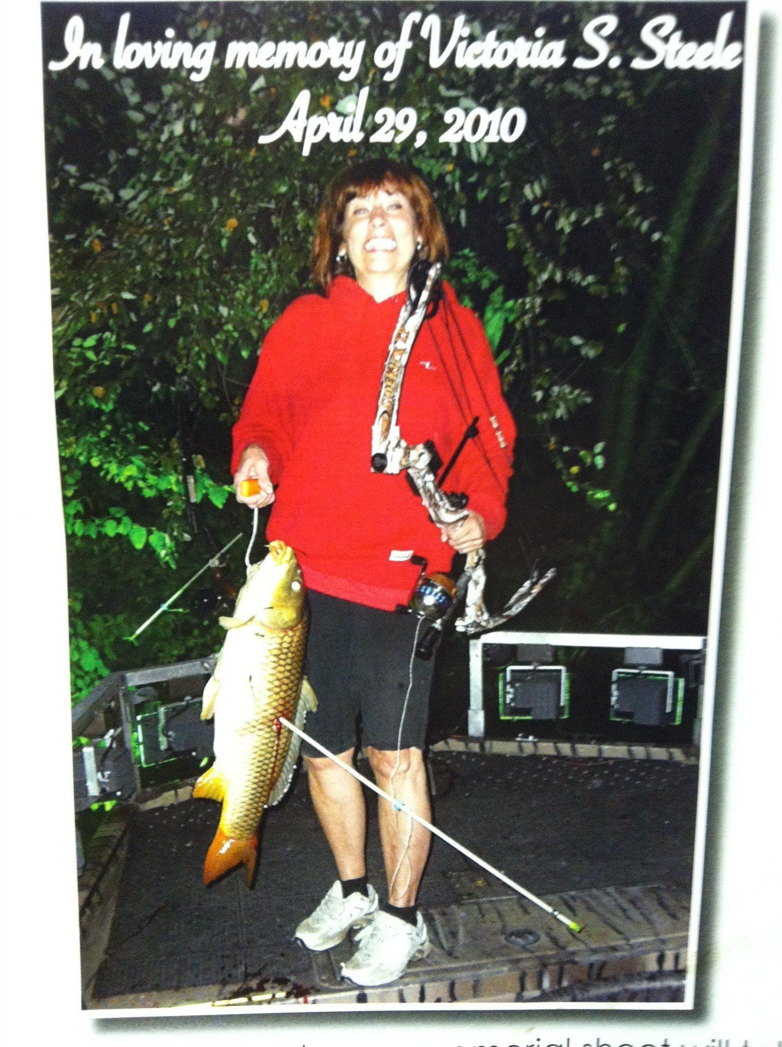 Woman in Hoodie Holding a Carp in a Hook — Lancaster County, PA — Night Ventures Bowfishing Charters