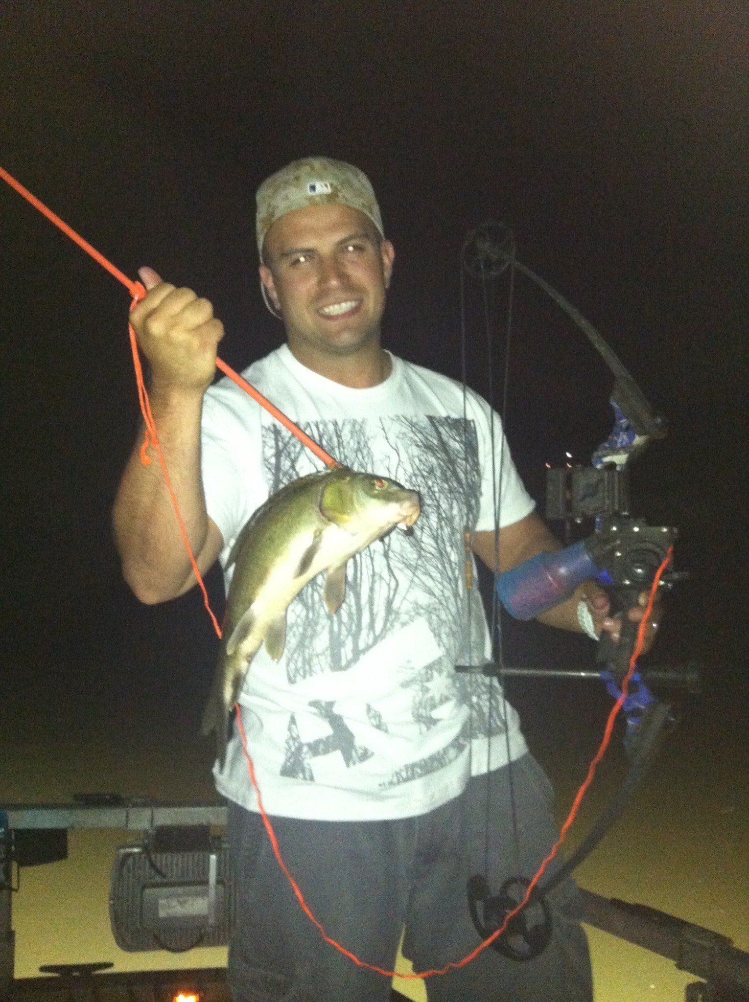 Man Holding a Bow and Arrow with Caught Fish — Lancaster County, PA — Night Ventures Bowfishing Charters