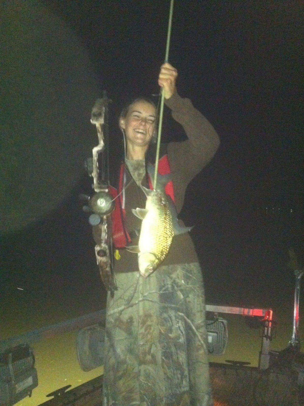 Happy Woman Holding a Fish Skewered in Arrow — Lancaster County, PA — Night Ventures Bowfishing Charters