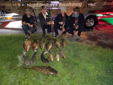 Bowfishing Charters — Four Men with their Fishes Laying on Grass in Lancaster County, PA Bowfishing Charters — Four Men with their Fishes Laying on Grass in Lancaster County, PA